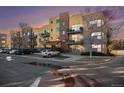 Exterior shot of a multi-unit complex with balconies and on-site parking under a sunset at 9039 E Panorama Cir # C201, Englewood, CO 80112