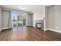 Cozy living room with a fireplace and sliding glass doors leading to a balcony at 9039 E Panorama Cir # C201, Englewood, CO 80112