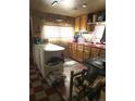 Functional kitchen featuring ample storage, countertop space, and a rustic stove at 10504 Jackson Creek Rd, Sedalia, CO 80135