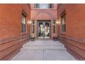 Elegant entrance with brick walls, step stones and double glass doors, with planters on each side at 1475 N Humboldt St # 22, Denver, CO 80218