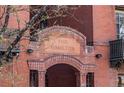 Close up exterior shot of The Hamilton building with red brick and an arched entrance at 1475 N Humboldt St # 22, Denver, CO 80218