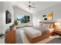 Brightly lit main bedroom with vaulted ceiling and large windows offering a beautiful view at 5005 W 128Th Pl, Broomfield, CO 80020