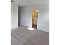 Neutral bedroom with a view into the bathroom showing tile and a shower with a glass door at 15267 Fillmore St, Thornton, CO 80602