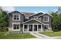 Two-story craftsman style home with gray siding and stone accents at 15267 Fillmore St, Thornton, CO 80602