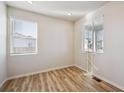 Bright bedroom featuring wood-look flooring, white walls and large windows at 1417 Bloom St, Brighton, CO 80601
