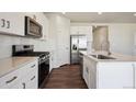 Stylish kitchen features white cabinets, stainless steel appliances, and a functional island at 1417 Bloom St, Brighton, CO 80601