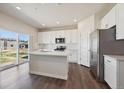 Bright, updated kitchen with white cabinets, stainless appliances, and an island at 1417 Bloom St, Brighton, CO 80601