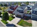 An aerial view shows a manicured lawn, driveway and the roof of this charming home at 20768 Randolph, Denver, CO 80249