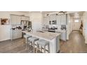 Bright kitchen with granite island, stainless steel appliances, and modern gray cabinets at 1885 Mount Monroe Dr, Berthoud, CO 80513
