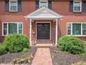 Inviting front entrance with double doors, trimmed with sidelights and a brick path leading to the street at 6953 S Prescott St, Littleton, CO 80120