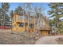 Beautiful two-story house with a spacious deck, showcasing its inviting entrance and garage at 643 Aspen Rd, Golden, CO 80401
