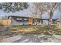 Charming single-story home with a well-maintained lawn, modern design, and attached garage at 9309 Highland Pl, Arvada, CO 80002