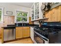 Efficient kitchen with stainless steel appliances and light wood cabinets at 1602 Garfield St, Denver, CO 80206
