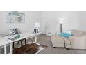 Home office with built-in desk and comfortable seating area at 10610 E 167Th Pl, Brighton, CO 80602