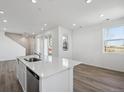 View of kitchen and living room with a quartz countertop island and stainless steel appliances at 1222 Penner Dr, Erie, CO 80026