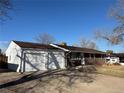 Cozy brick home with a two-car garage, mature trees, and a well-maintained front yard at 2357 E Mineral Ave, Centennial, CO 80122