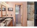 Stylish bathroom featuring double sinks, dark countertops, and an adjacent bathtub at 112 Grey Squirrel Ln, Breckenridge, CO 80424