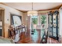 Formal dining room with large windows, a grand table, and a stylish display cabinet at 112 Grey Squirrel Ln, Breckenridge, CO 80424