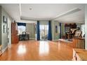 Spacious living room with hardwood floors, a wall of windows, and a dedicated office space at 300 W 11Th Ave # 15F, Denver, CO 80204