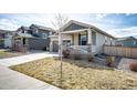 Well-maintained home featuring a two-car garage, covered porch, and tidy front yard landscaping at 929 Honey Berry Ct, Elizabeth, CO 80107