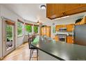 Spacious kitchen features a breakfast bar, stainless steel appliances, and ample counter space for cooking at 1205 W 11Th Ct, Broomfield, CO 80020