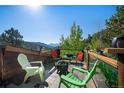 Relaxing outdoor deck area with comfortable seating, a fire pit, and scenic mountain views at 1575 York Gulch Rd, Idaho Springs, CO 80452