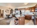 Open kitchen featuring an island, stainless steel refrigerator and dining area at 7292 S Blackhawk St # 2-204, Englewood, CO 80112