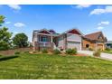 Attractive home featuring neutral siding, stone accents, and a well-maintained front yard at 265 Calhoun Cir, Castle Rock, CO 80104