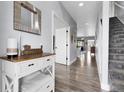 Bright entryway featuring hardwood floors, staircase, and tasteful decor, creating a welcoming atmosphere at 484 N Jamestown Way, Aurora, CO 80018