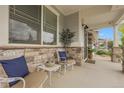 Inviting front porch featuring decorative stone accents, comfortable seating, and pleasant outdoor ambiance at 484 N Jamestown Way, Aurora, CO 80018