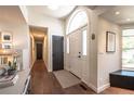 Inviting foyer boasts a hardwood floor, arched window above the front door, and a view of the hallway at 995 Chase St, Lakewood, CO 80214