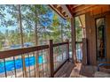 Balcony view overlooking a pool surrounded by pine trees and natural beauty at 820 Columbine Rd # 10, Breckenridge, CO 80424