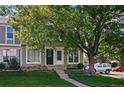Charming townhome with a well-maintained lawn and mature tree in front at 2291 S Jasper Way # B, Aurora, CO 80013