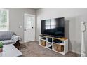 Cozy living room featuring neutral walls, carpet, and entertainment center at 2291 S Jasper Way # B, Aurora, CO 80013