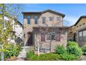 Charming two-story home boasts a well-manicured front yard, beautiful landscaping, and inviting curb appeal at 15525 W La Salle Ave, Lakewood, CO 80228