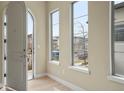 Bright foyer with arched doorway, light hardwood floors, and natural light at 15525 W La Salle Ave, Lakewood, CO 80228