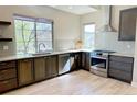 Modern kitchen with stainless steel appliances, granite countertops, and ample cabinet space at 15525 W La Salle Ave, Lakewood, CO 80228