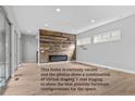 Vacant living room showcases wood accent wall and provides furniture configuration options for a buyer to stage at 15525 W La Salle Ave, Lakewood, CO 80228