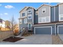 Charming townhome with modern blue siding, a well-maintained yard, and an attached garage at 1828 Blue Oak Ct, Castle Rock, CO 80104