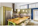 Spacious kitchen with a large island, stainless steel appliances, and unique cabinets at 2432 Champa St, Denver, CO 80205