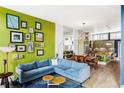 Open-concept living room flows into the dining area and kitchen with natural light at 2432 Champa St, Denver, CO 80205