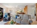 Relaxing living area featuring a kitchen view, dining space, and comfortable seating at 771 Canyon Dr, Castle Rock, CO 80104