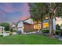 Charming home with manicured lawn, rock garden, and mature tree at 18126 E Alamo Dr, Centennial, CO 80015