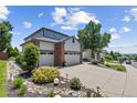 Well-maintained home with three-car garage, manicured landscaping, and a spacious driveway at 18126 E Alamo Dr, Centennial, CO 80015