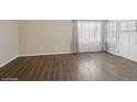Bright living room with hardwood floors, large windows, and neutral walls at 4762 S Clay Ct, Englewood, CO 80110
