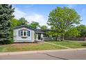 A single-story home with a tidy lawn, mature trees, and great curb appeal at 886 S Jersey St, Denver, CO 80224