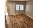 Cozy living room with laminate wood flooring, lots of natural light, and light gray walls at 7835 Barbara Ann Dr # C, Arvada, CO 80004