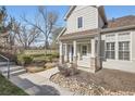 Charming home featuring a covered front porch, stone accents, and manicured landscaping, creating inviting curb appeal at 8300 Fairmount Dr # J105, Denver, CO 80247