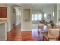 Open dining area featuring hardwood floors with views into living room and kitchen at 8594 W Quarto Ave, Littleton, CO 80128