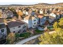 Lovely backyard with deck, patio, playground, and manicured lawn surrounded by neighboring homes at 1271 Sky Rock Way, Castle Rock, CO 80109